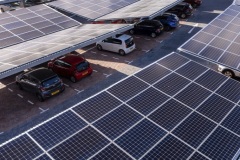 Warehouse smiling colleagues scanning cardboard box barcode and